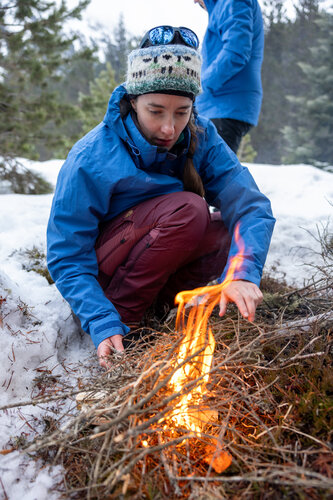 ESA astronaut candidate Rosemary Coogan lighting a fire during winter survival training in the snowy mountains of the Spanish Pyrenees as part of her basic astronaut training. 